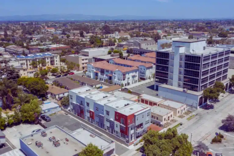 Downey, California street lined with palm trees at sunset showcasing the city’s vibrant business and residential district.