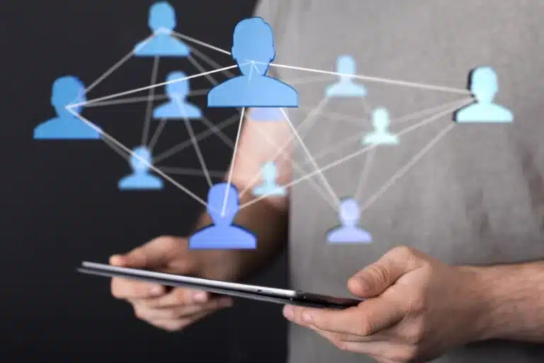 Person holding a tablet with digital network icons representing automated LinkedIn connections and outreach.
